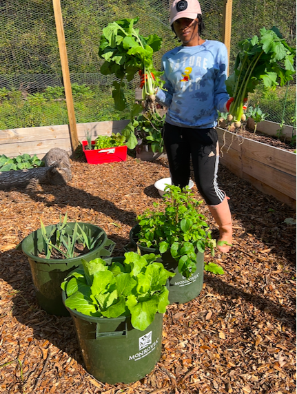 Takeya shows off some of the produce grown in her garden 