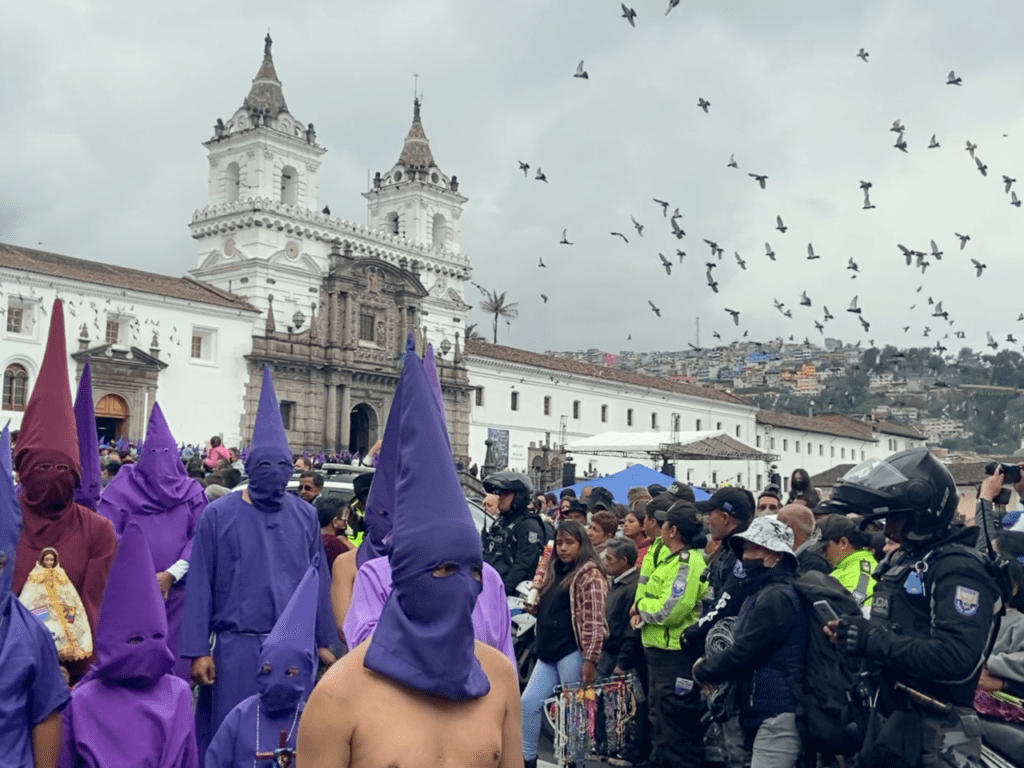 Celebrants gather as authorities manage the crowds at the Church of San Francisco de Quito on Good Friday morning.