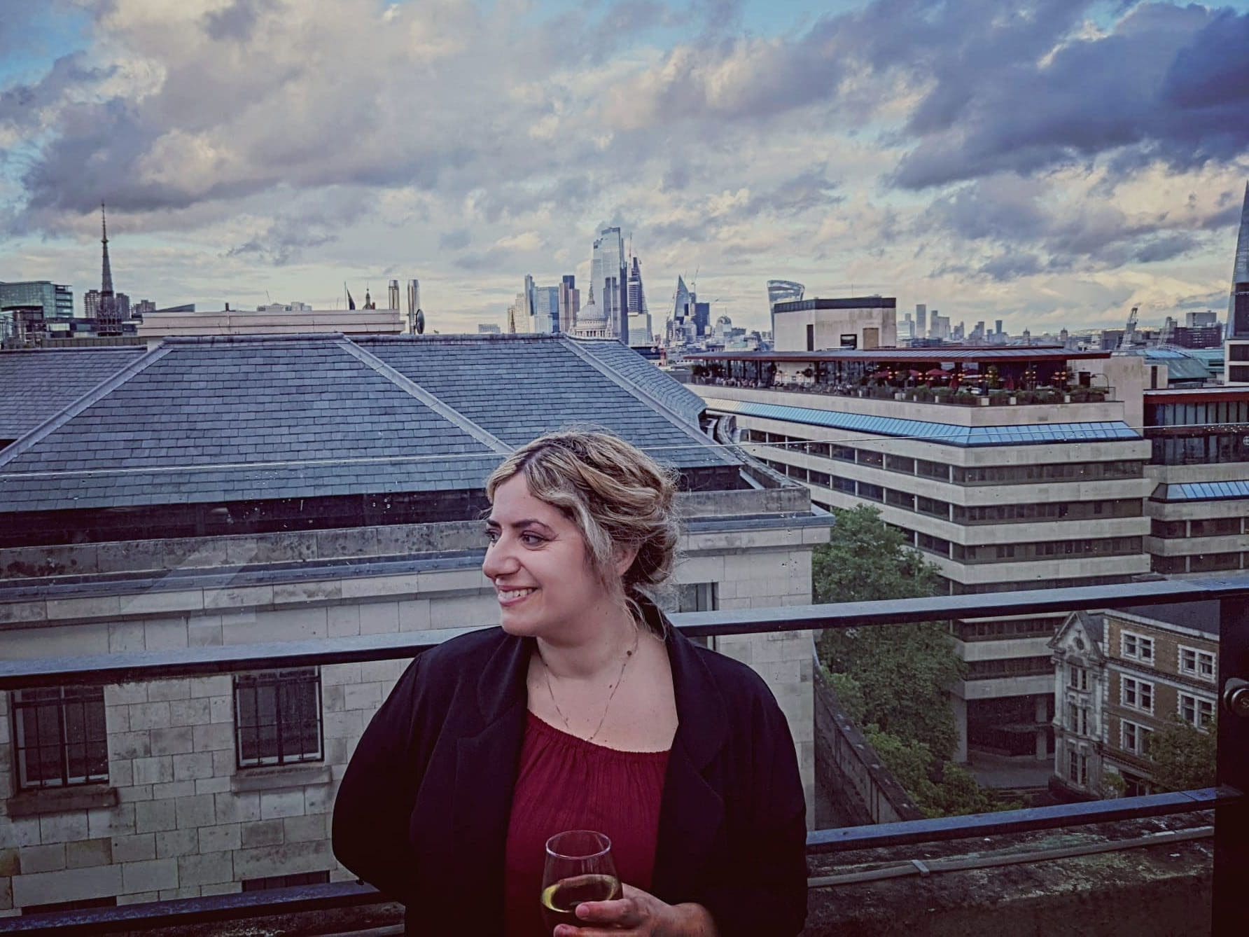 Gaby Sambuccetti celebrates on a London rooftop after receiving the prestigious Cosmos Davenport-Hines Prize for poetry