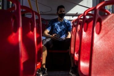 Joan Manga gets on the bus before anyone else each day on his way to the athletics stadium, an athlete and coach. Photo by David Moran.