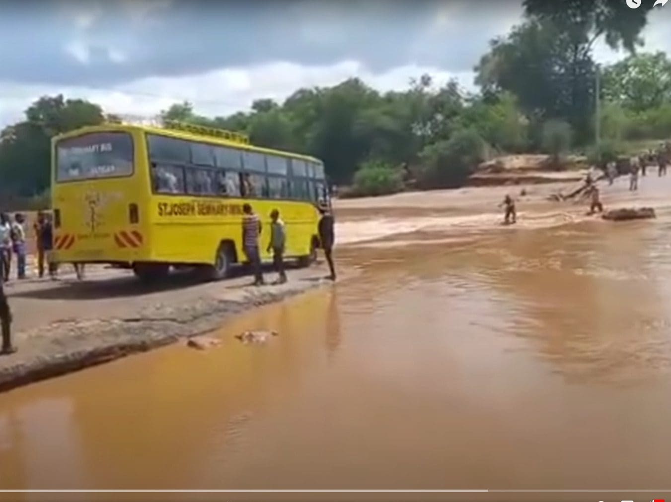 The bus full of people shown seconds before it tipped into the flooded Enziu River. So far, the death toll is at 33, including several children