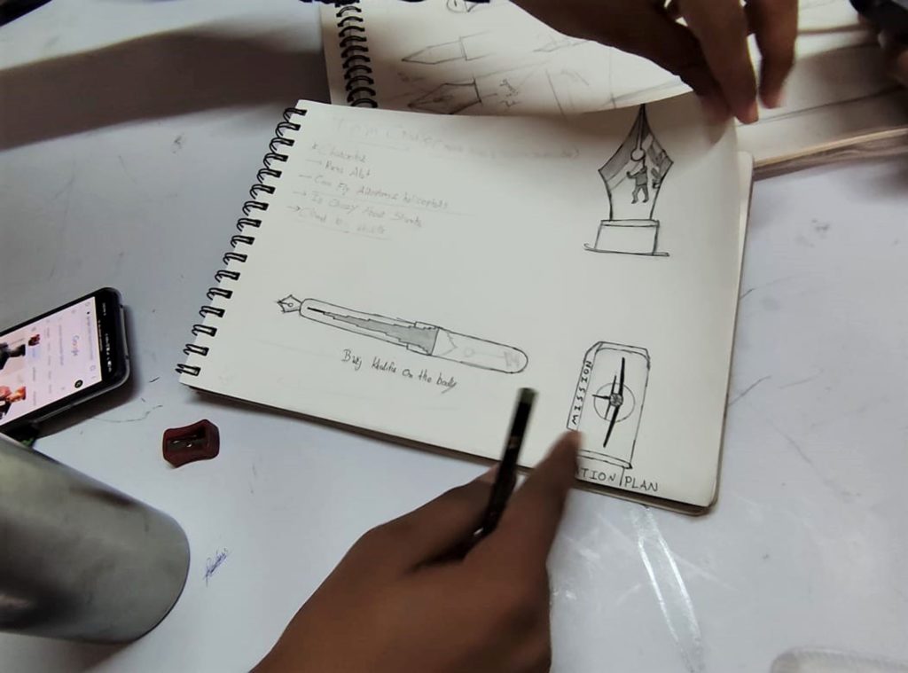 One of Professor Yashwant Dattatreya Pitkar's students sketches a fountain pen they designed