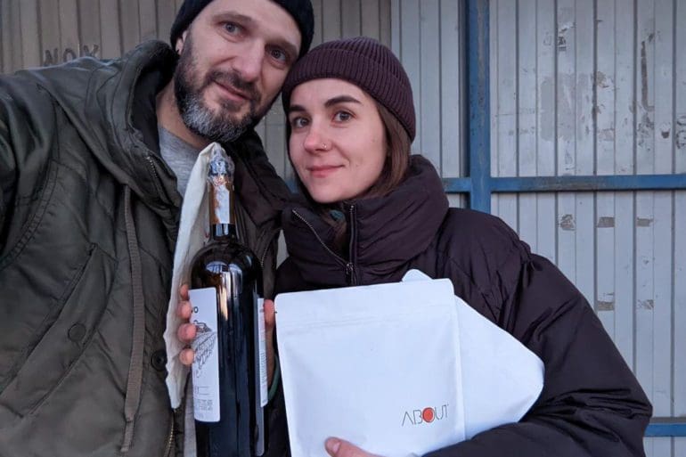 Svitlana Lytvak and her partner Alex, co-owners of About Coffee in Cherkasy, Ukraine, hold a Molotov cocktail and a bag of coffee beans