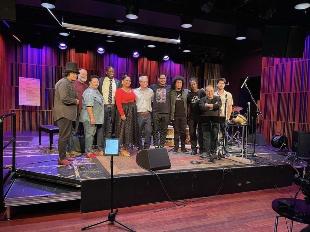 The band stands on the stage of the Jazz Museum event in New Orleans, where they got to perform and record a video. The band is known for bringing Honduran culture and traditions to the world of jazz all around the world.