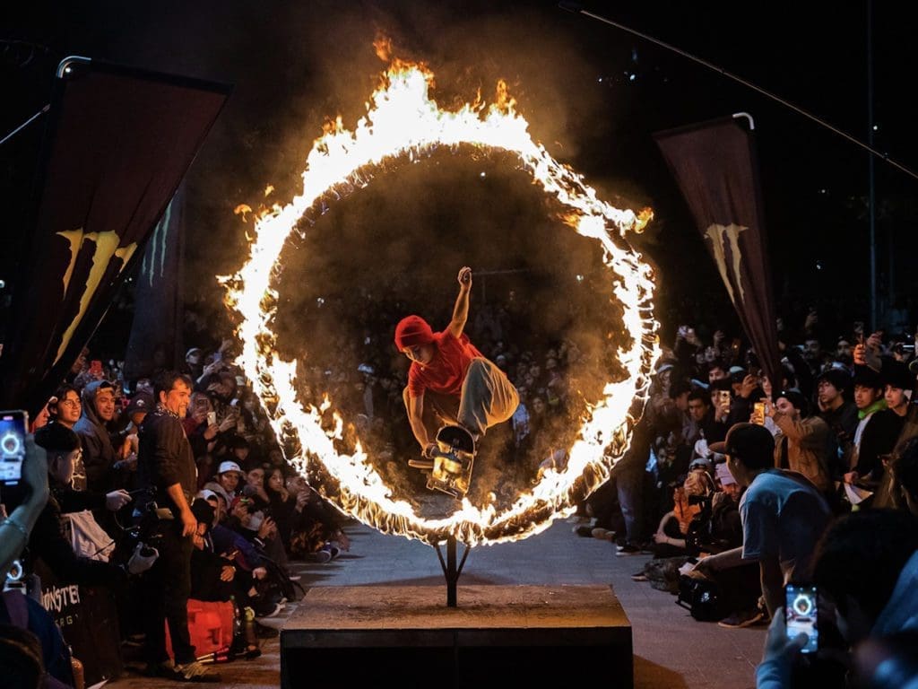A skateboarder jumps through a fire ring installed at Skate Park Bustamante, as part of the celebration of International Skateboarding Day 2023 in Santiago, Chile.
