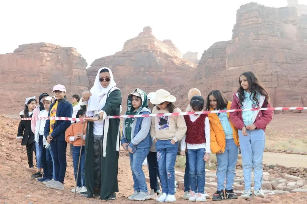 Shahad Bedair, one of the very first female tour guides in Saudi Arabia, leads a group of tourists around Alula