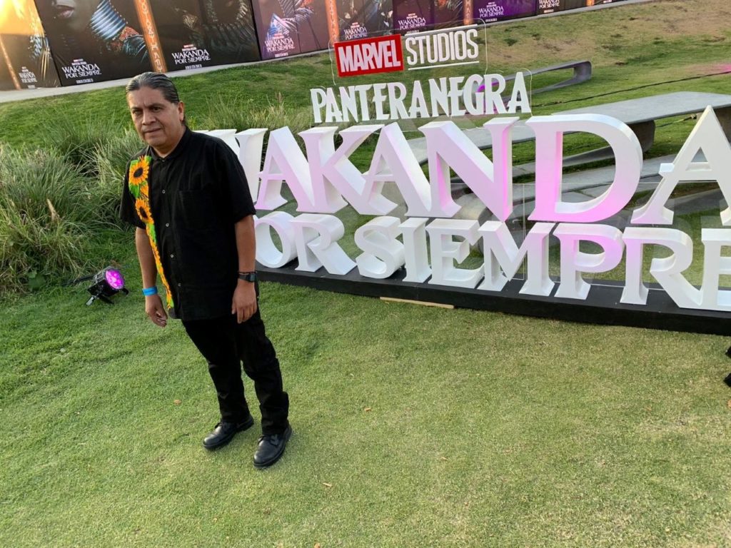 The musician stands in front of the movie sign at the presentation of the Marvel Studios film Black Panther: Wakanda Forever